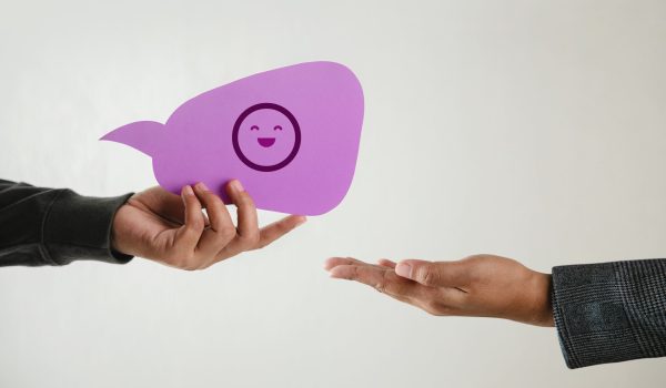 Customer Experience Concept. Happy Client giving a Smiling Emoticon to a Businessman. Feedback on Bubble Speech Card. Positive Review. Satisfaction Survey